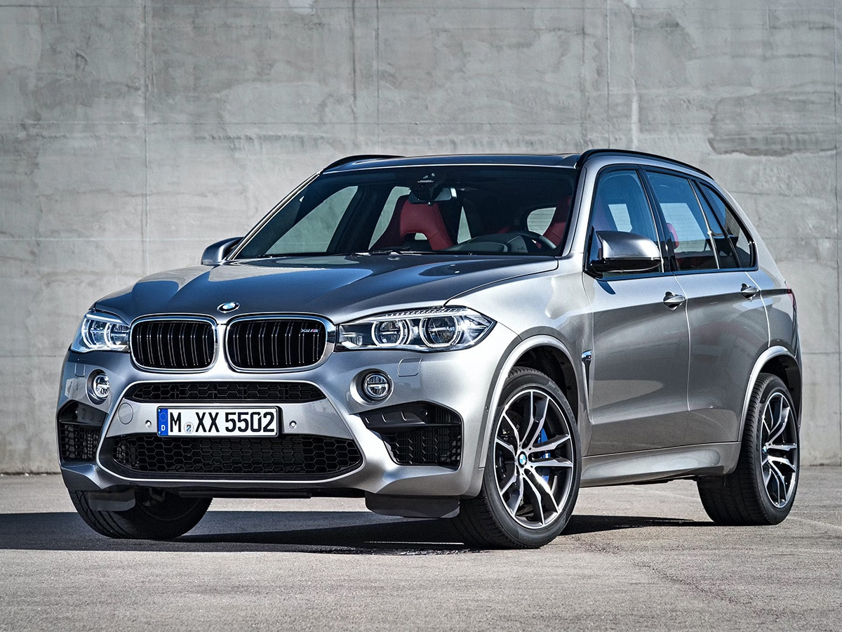 BMW X5 đen nổi bật băng qua đường đồi thoải